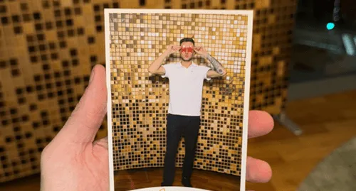 69a80426bc3ec7b1131974a2_contacts-image-p-500 Printed photo strip from a photo booth held in a hand