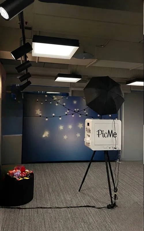69ada50fd9fd1d6d5194cfcc_1s Photo booth with studio lighting set up in an event room