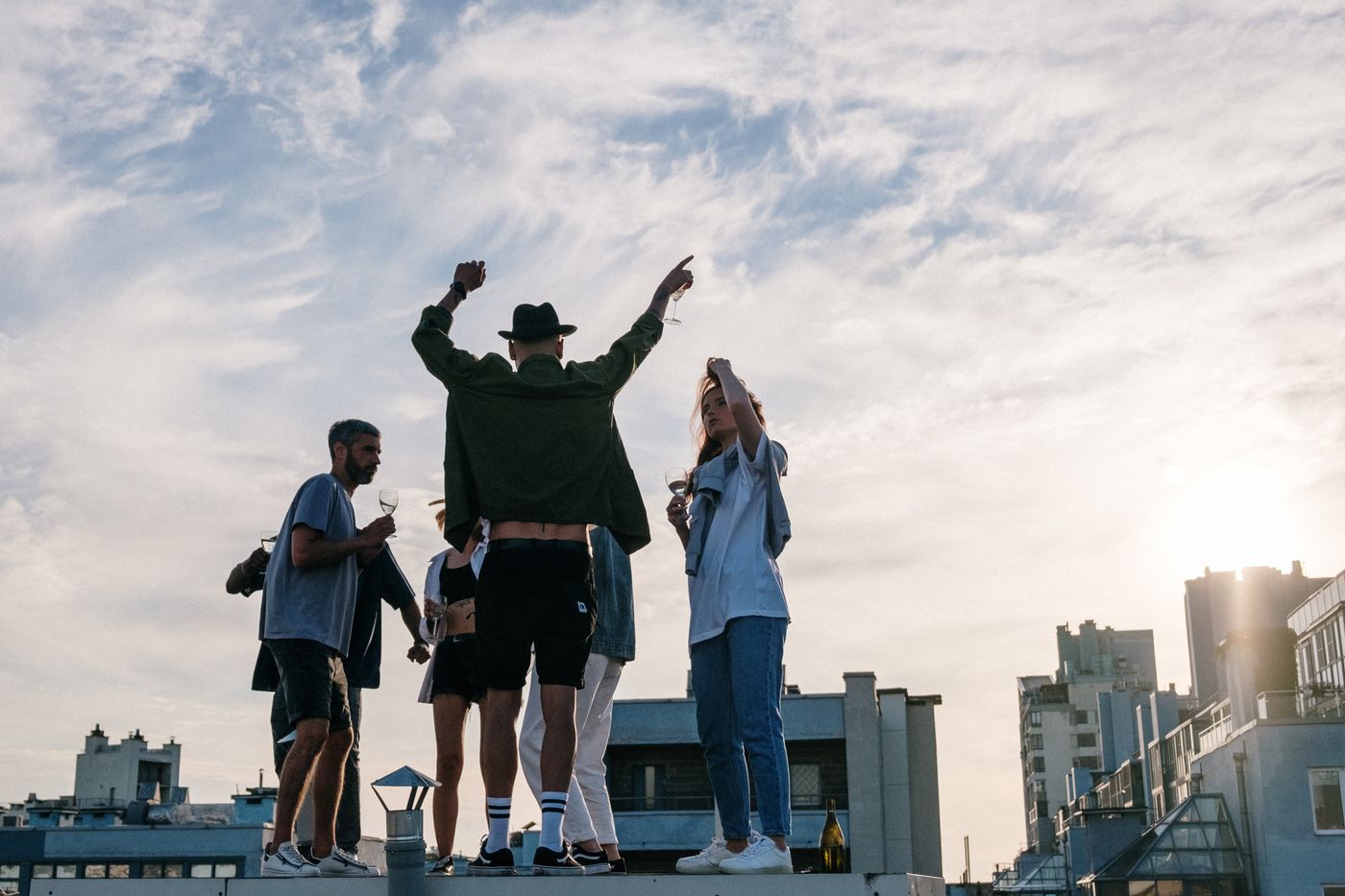 Guests celebrating on a sunny Malaga rooftop terrace with a city view